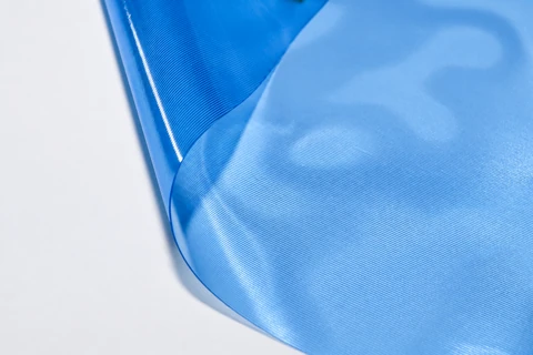 Close-up of a blue PVC sheet and its curved edge